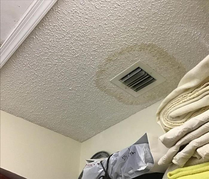 Stain on ceiling around air vent.