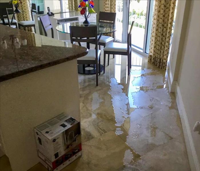Flood water on the floor of a kitchen in a Deerfield Beach home